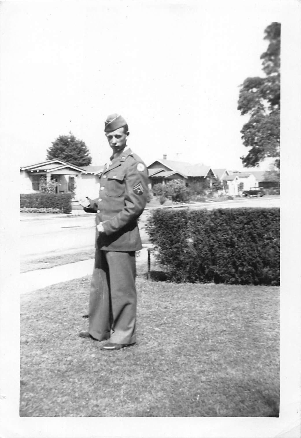Soldier on residential lawn in dress uniform