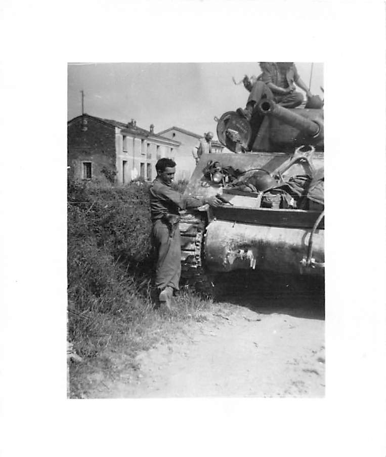 Soldier leaning on Sherman tank in Italian village