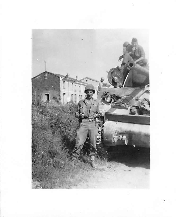 Soldier with M1 helmet in front of tank