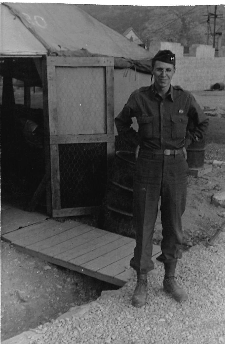 Soldier near chicken wire in Italian hill village