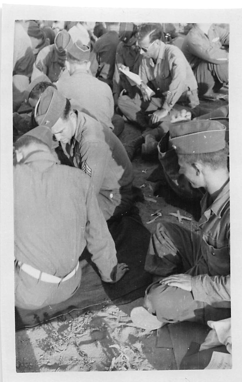 Soldiers reading orders outdoors