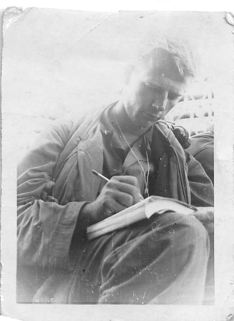 Soldier writing in a notebook
